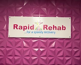 Rapid Rehab sign on a magenta feature wall